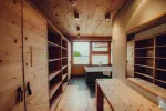 Bright wooden interior with shelves and a table
