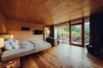 Cozy room with wooden ceiling, bed, and view of nature