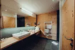 modern bathroom with wooden accents and double sink