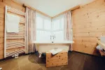 stylish bathroom with wooden accents and a bathtub