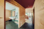Interior hallway with wooden walls and doorways leading to other rooms