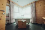 Bright bathroom with a freestanding tub and wooden accents