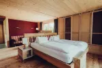 modern bedroom with wooden furniture and large windows