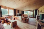 cozy interior with large windows, wooden flooring, and seating area