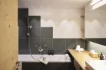 modern bathroom with bath, shower, and wooden countertop