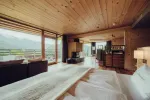 Modern interior with wooden walls and large windows showcasing a view
