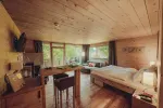cozy bedroom with wooden decor and large windows