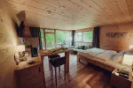 wooden bedroom with large windows and natural light