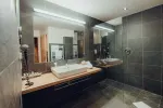 modern bathroom with wooden counter and large mirrors