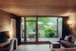 cozy living room with wooden ceiling and patio view