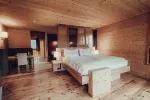 Wooden bedroom with a large bed and minimalist decor