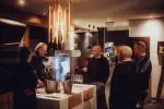 People gathered around a table in a modern interior setting